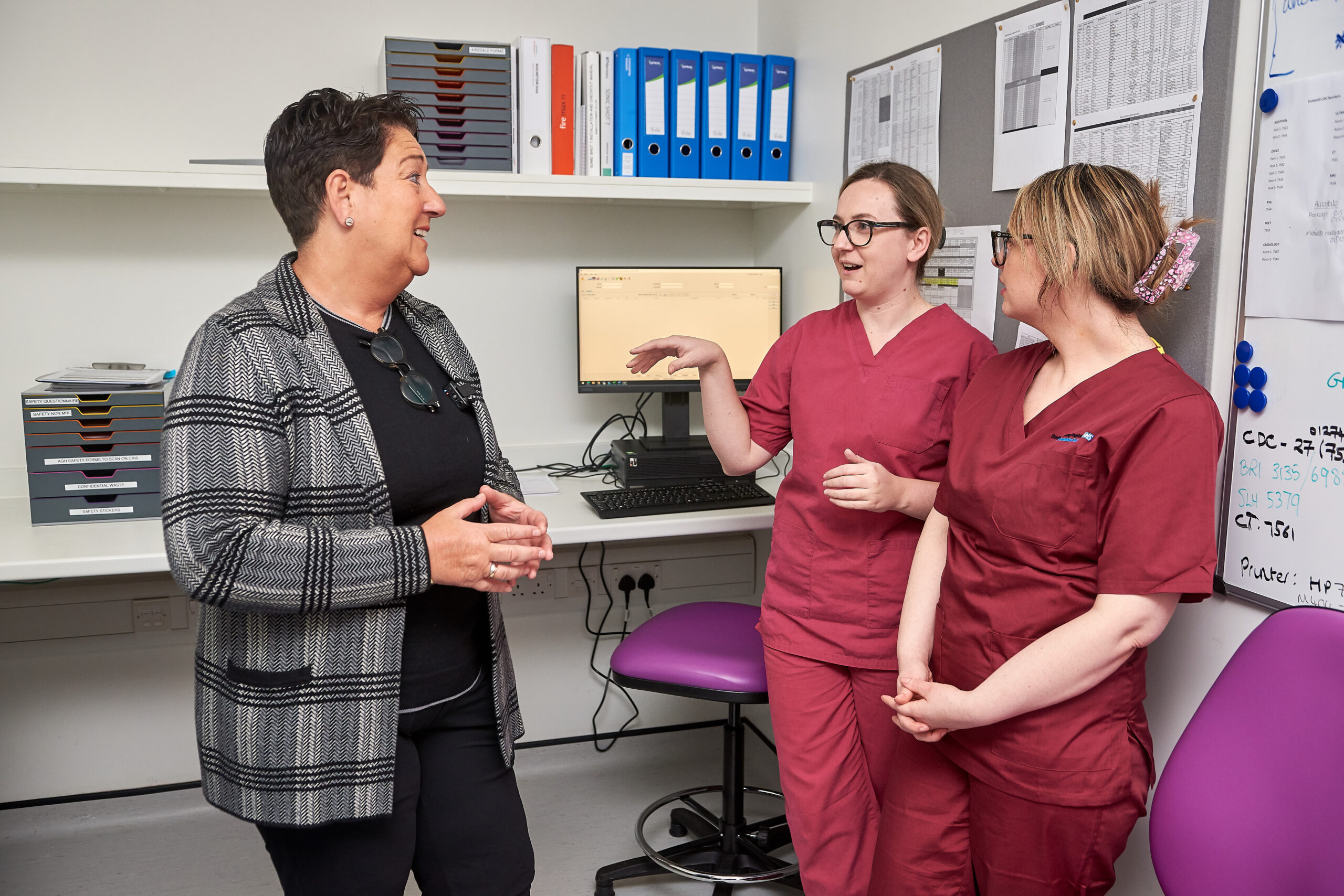 Mel Pickup talking to two radiologists.