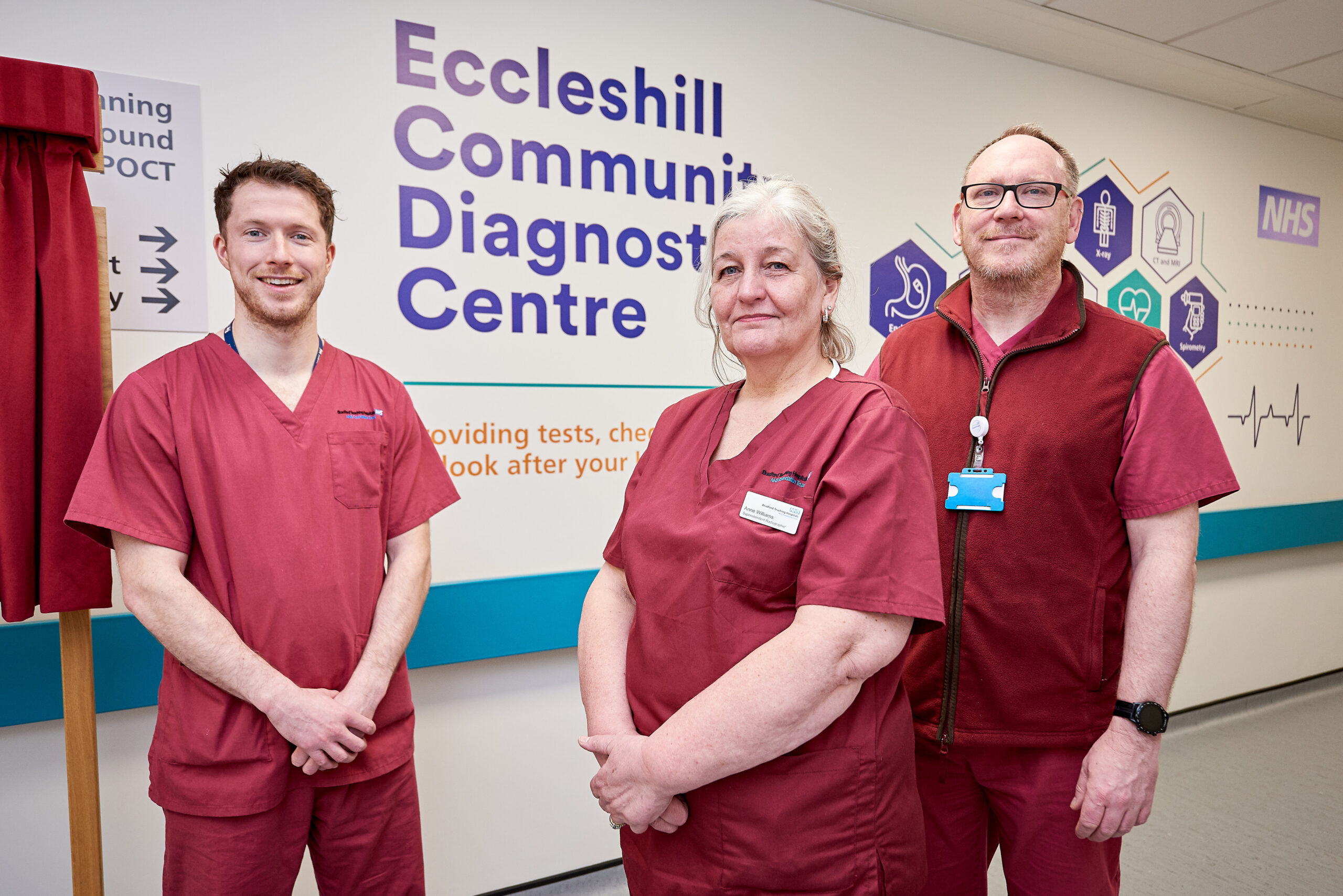 Picture of three people in red scrubs