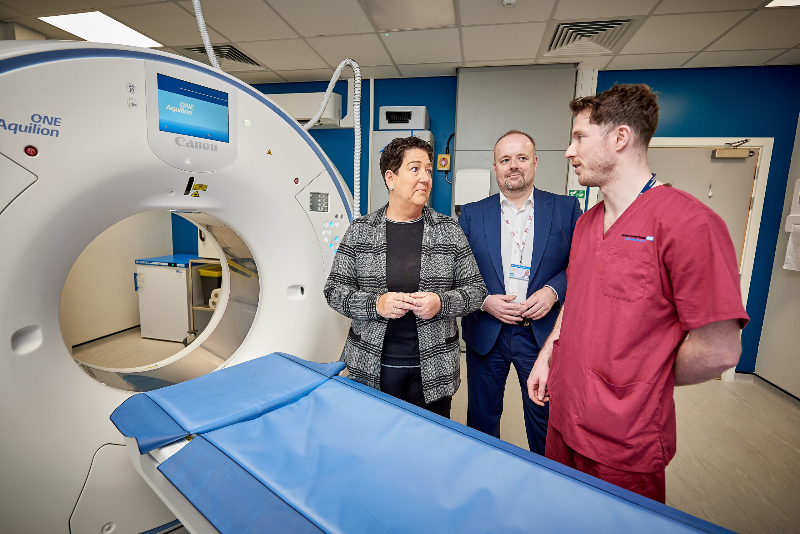 Picture of Mel Pickup, David Crampsey and radiographer in front of CT machine
