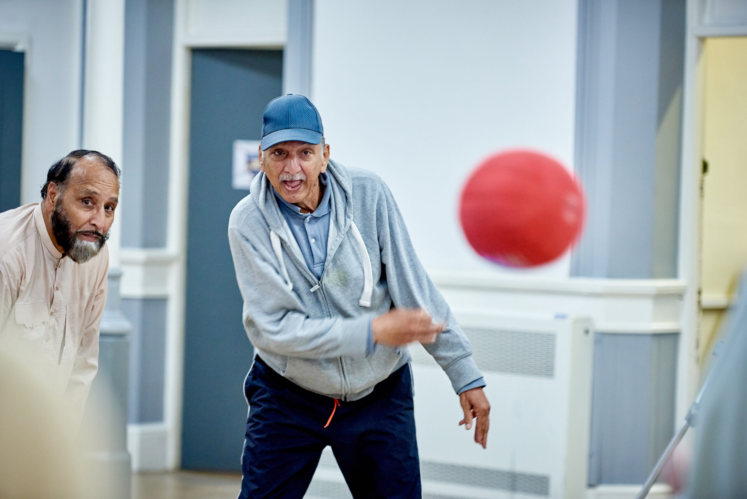 Two men passing a football
