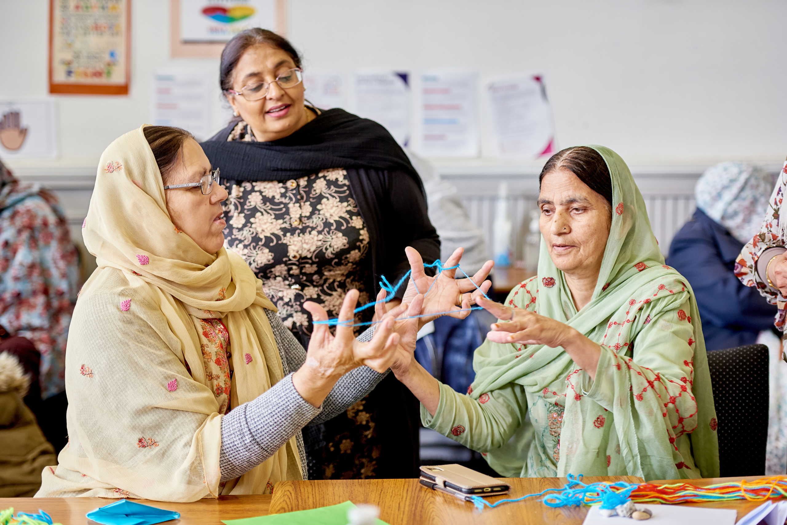 Two women playing cats cradle